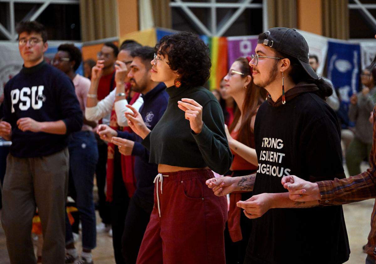 The crowd snaps along to a song by Las Cafeteras during the Indigenous Peoples Day Feast on Monday, Oct. 9, 2023 at the HUB Robeson Center on the Penn State campus.