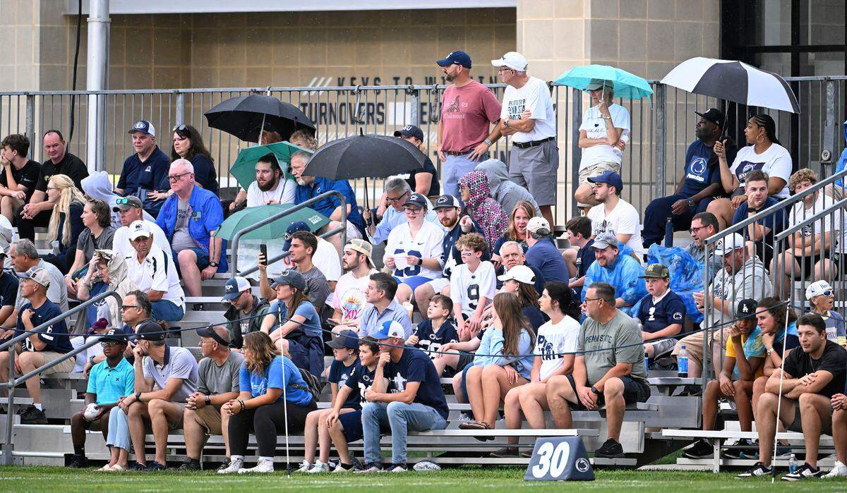 Fans sat through the rain to watch Penn State’s open football practice at the Lasch practice field Saturday, Aug. 12, 2023.