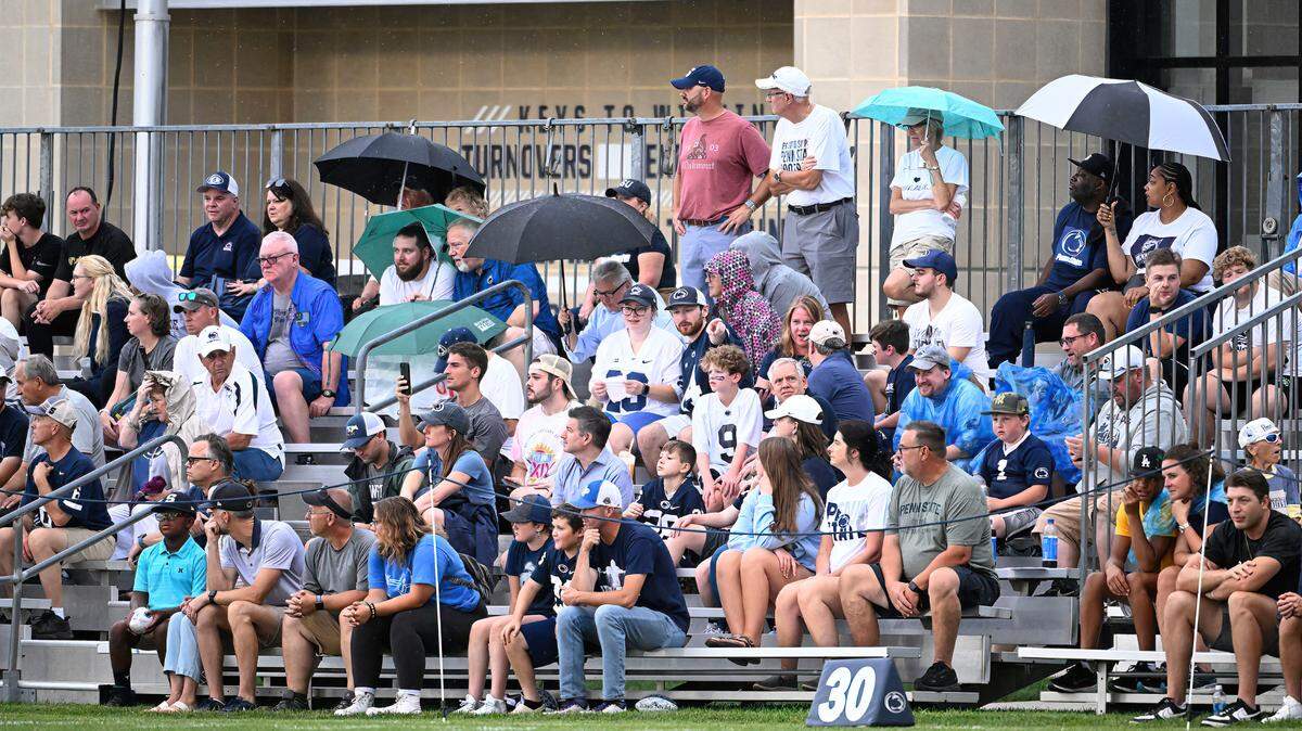Fans sit through the rain to watch Penn State’s open football practice at the Lasch practice field in this 2023 photo. Here’s what to know about a possibly soggy spring in State College this year.
