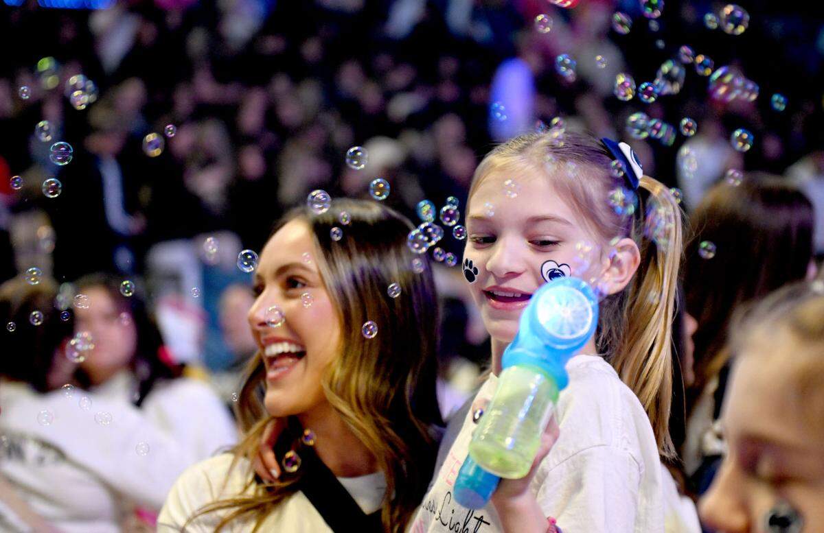 Shiloh Crimmel, 8, blows bubbles with the dancers from the Lionettes during Penn State Thon on Friday, Feb. 21, 2025.