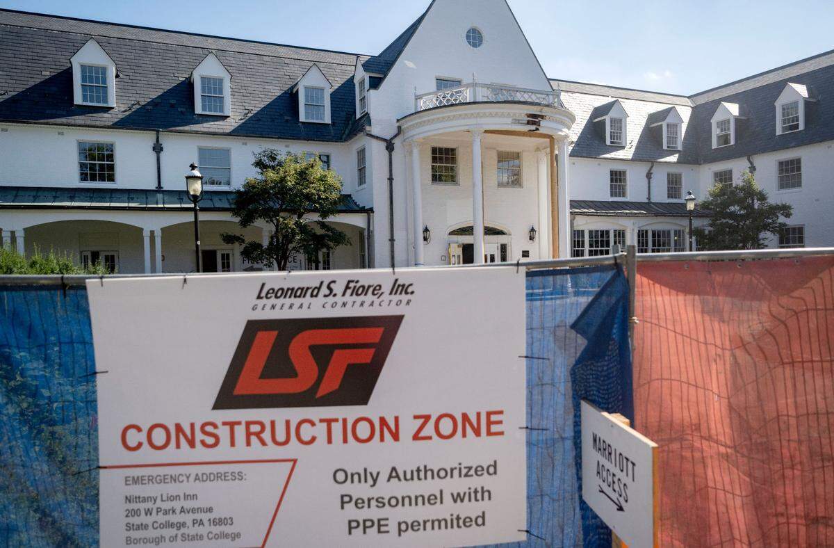 Construction fences surround the Nittany Lion Inn as renovations are happening on Monday, Oct. 4, 2023.