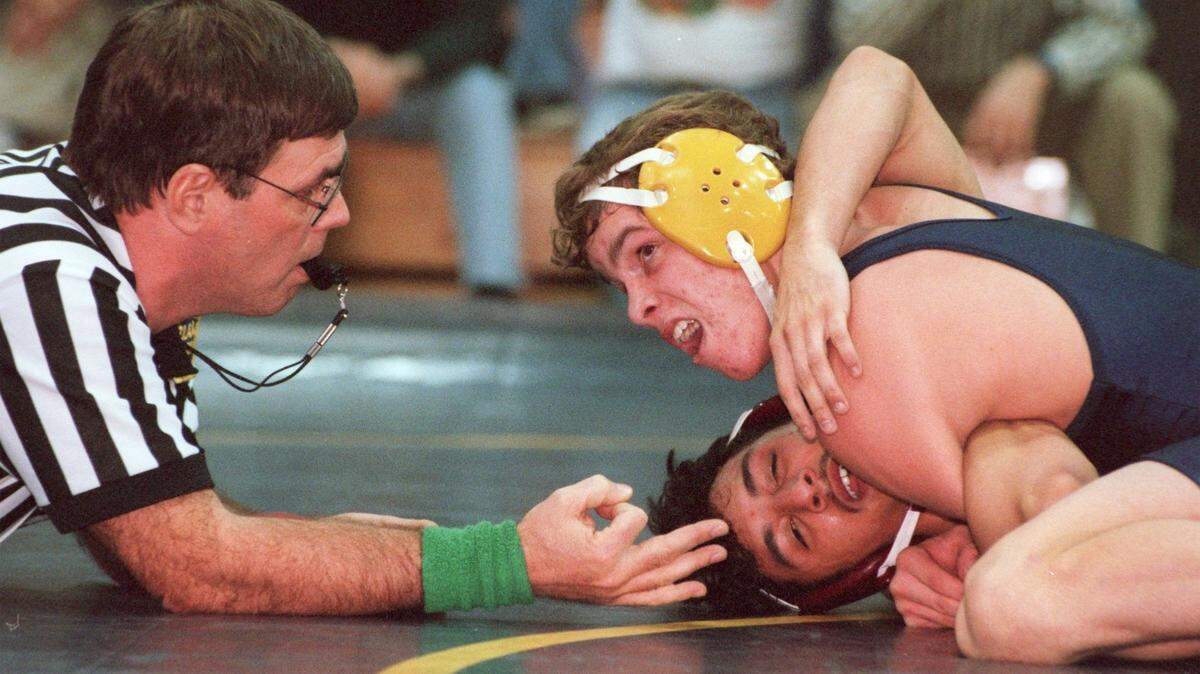 Bald Eagle Area’s Corey Geunot looks at referee Dick Wood after scoring three near-fall points during his 10-5 win over Shikellamy’s Anthony Rivera at 125 pounds in Wingate in 1998.