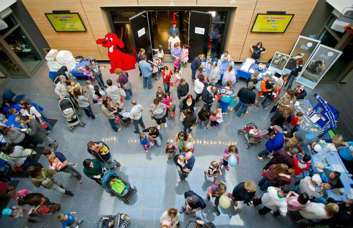 Visitors browse the PBS characters and science demonstrations during Cat-a-palooza, WPSU’s family open house on Oct. 13, 2014 at Innovation Park. 