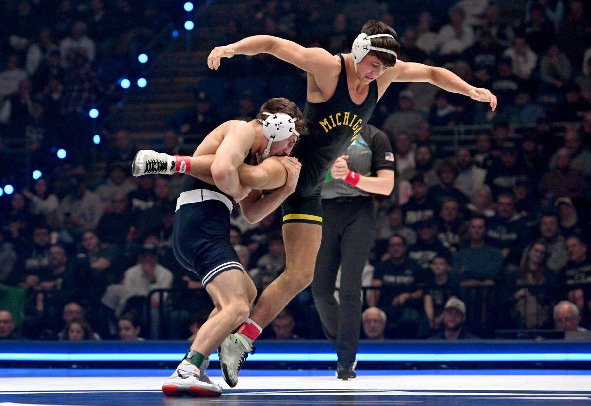 Penn State’s Mitchell Mesenbrink trips up Michigan’s Beau Mantanona in the 165 lb bout of the match on Friday, Feb. 7, 2025 in the Bryce Jordan Center. Mesenbrink won by major decision, 18-4.