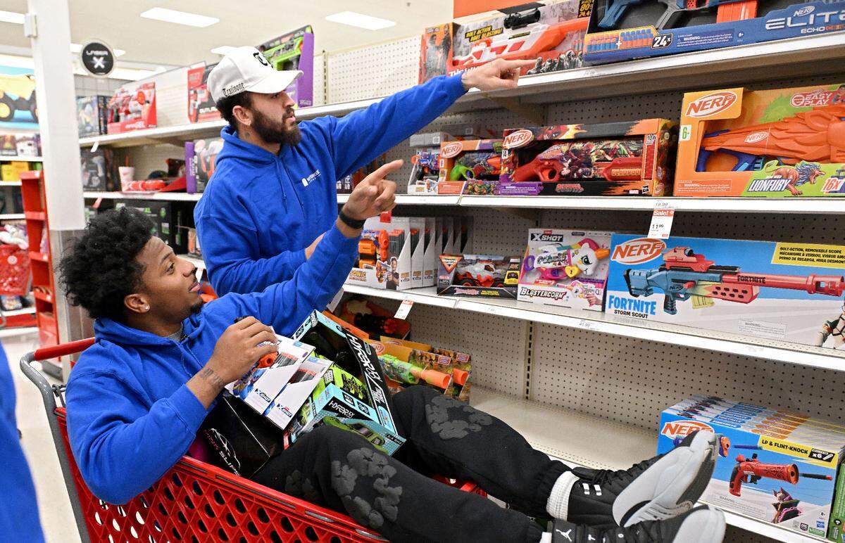 Penn State football players DaKarri Nelson and Julian Fleming debate which nerf guns to get during a shopping spree with West Shore Home for Toys for Tots on Monday, Dec. 2, 2024.