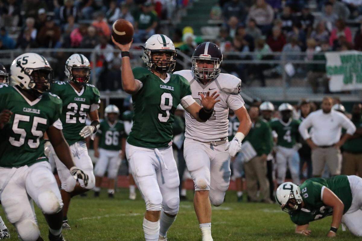 State College DE Nathan Lusk pressures Carlisle QB Owen Hacker on Sept. 13. The Little Lions won 52-12.
