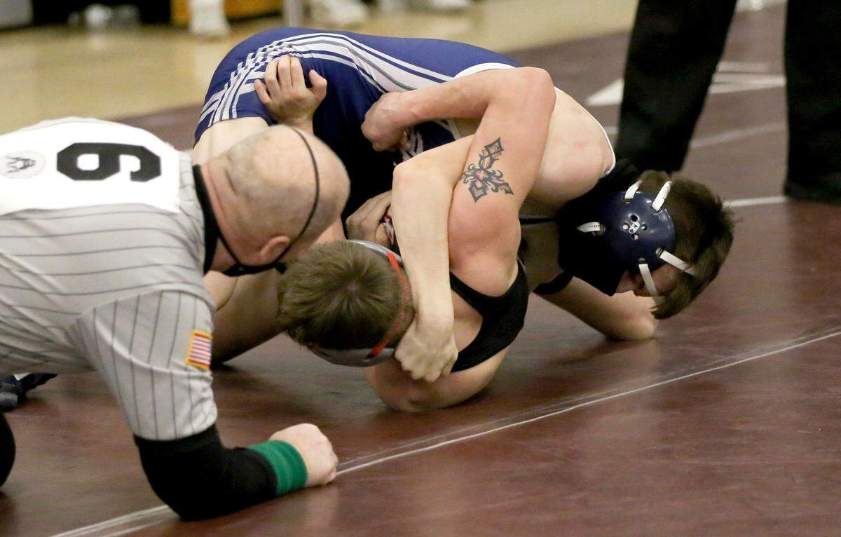 Penns ValleyÕs Justin Darlington rolls Ian Crouch for a pin in the 126 lb third place bout at the District 6 AA wrestling on Saturday, Feb. 20, 2021.