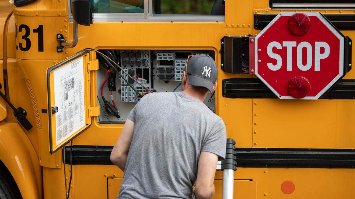 Workers from Bus Control install cameras in Kauffman buses in Hampden Township in October.
