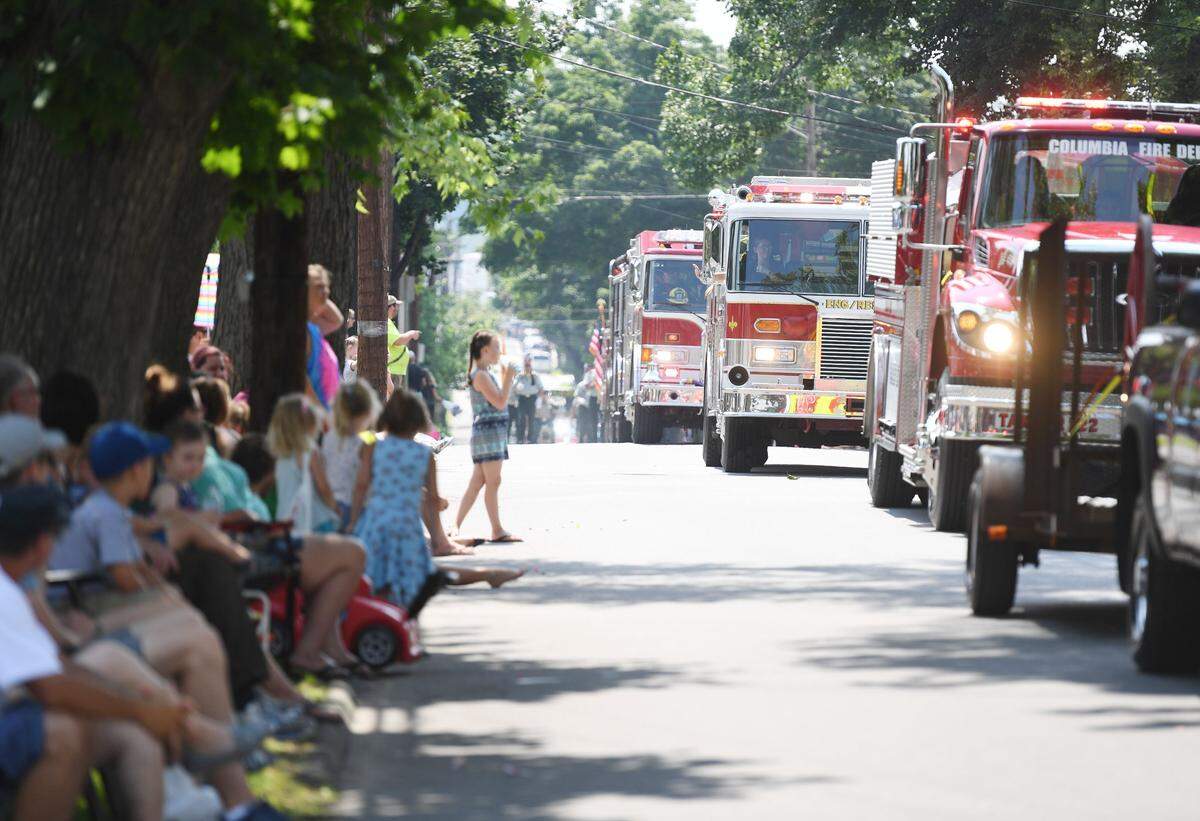 Attendees watch as fire engines drive by during the 2018 Heritage Days Grand Parade in Philipsburg.