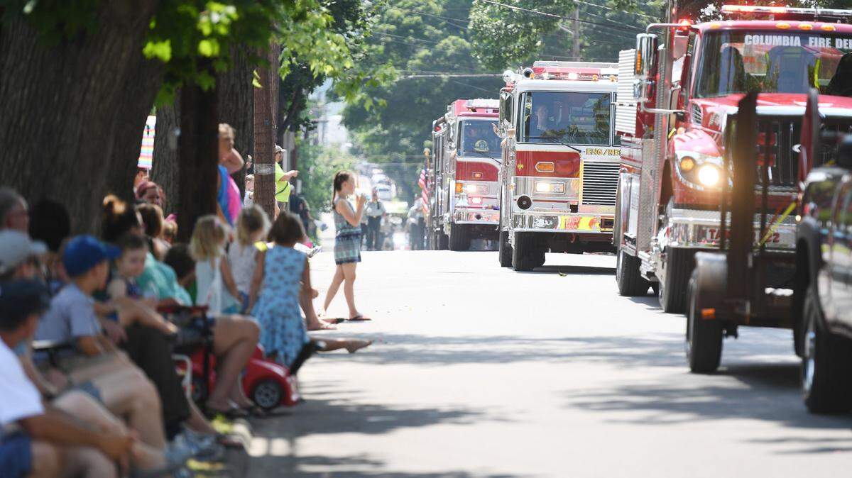 Attendees watch as fire engines drive by during the 2018 Heritage Days Grand Parade in Philipsburg.