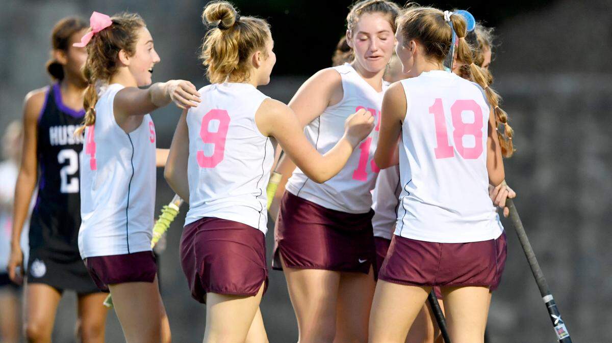 State College field hockey players wear pink and white jerseys on Oct. 6 during the Stick it to Cancer game.