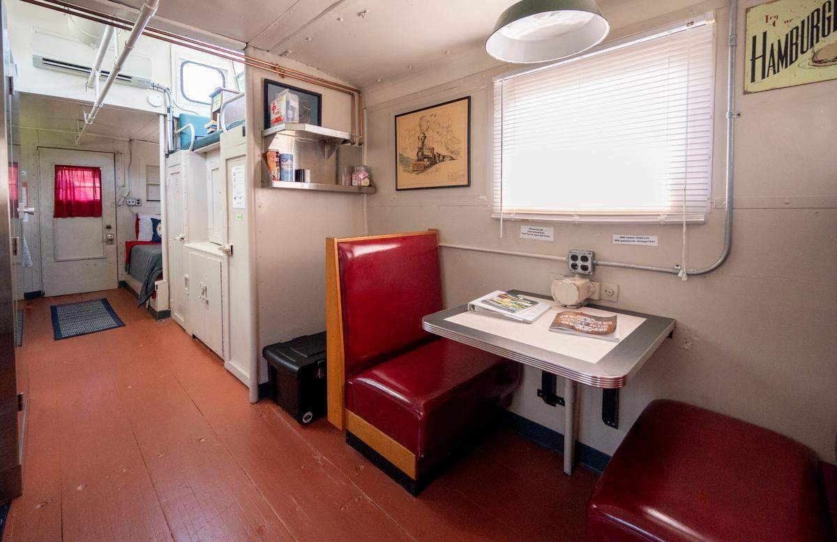 A seating area, bathroom and shower and two single beds are in the 1941 caboose at the Castanea Railroad Station that visitors can stay in.