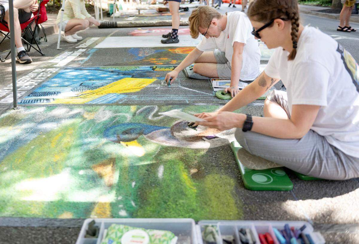 Kyle Cramer and Alison Laninger work on their Italian street paintings during the Central Pennsylvania Festival of the Arts on Friday, July 11, 2025.