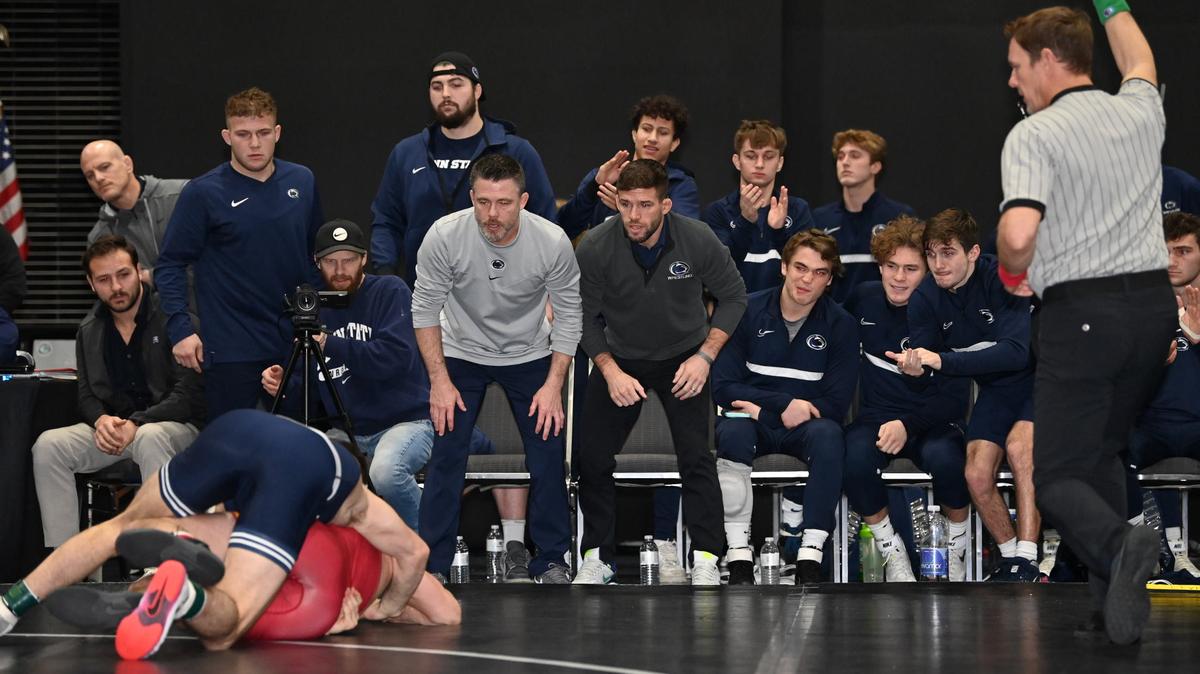Penn State coaches and wrestlers watch as Levi Haines secures a takedown in his 157-bout of the Nittany Lions’ 22-12 win over Iowa State on Tuesday. Haines won 8-3 as Penn State claimed the Collegiate Duals Blue Pool title.