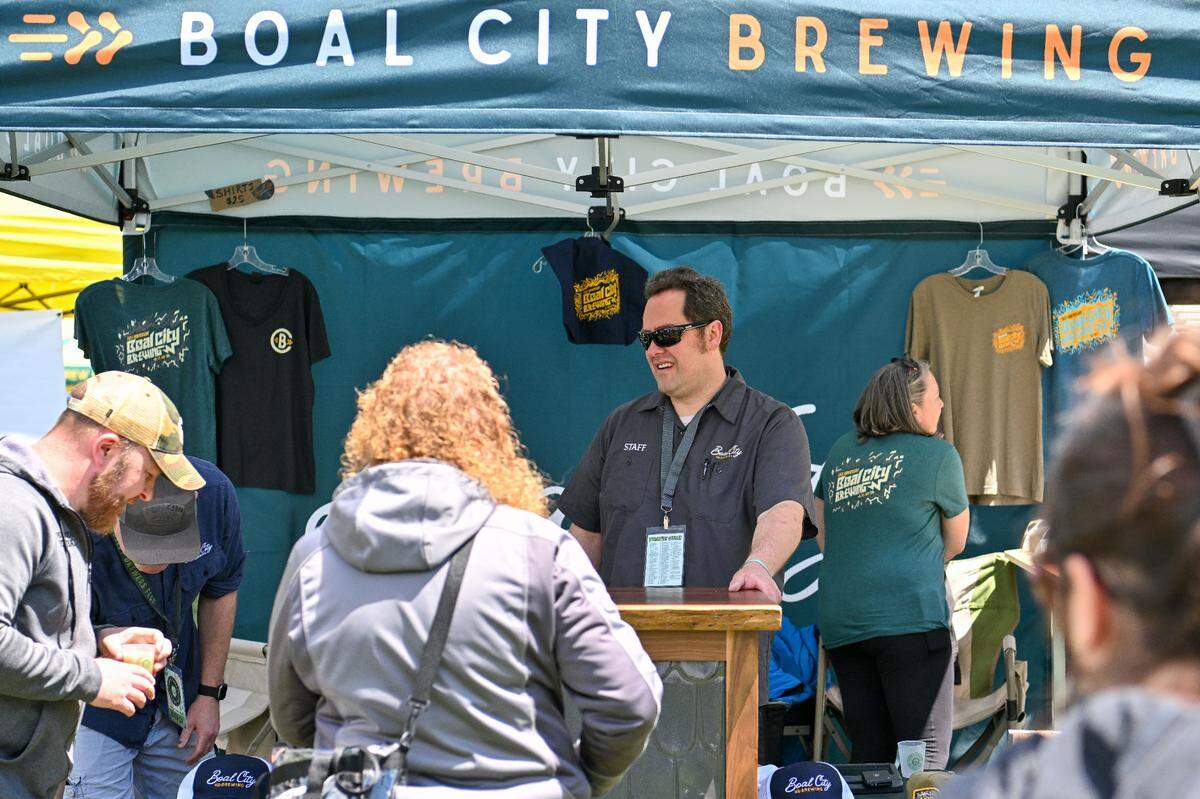 Mike Smith, brewmaster at Boal City Brewing, prepares to serve attendees Saturday at the Hoppy Valley Brewers Fest at Penn State’s Beaver Stadium.