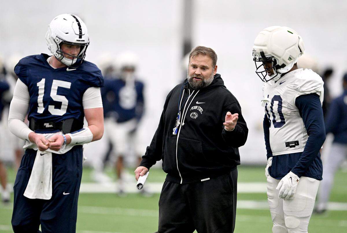 Penn State offensive coordinator Andy Kotelnicki talks with Drew Allar and Nick Singleton during spring practice on Tuesday, April 8, 2025.
