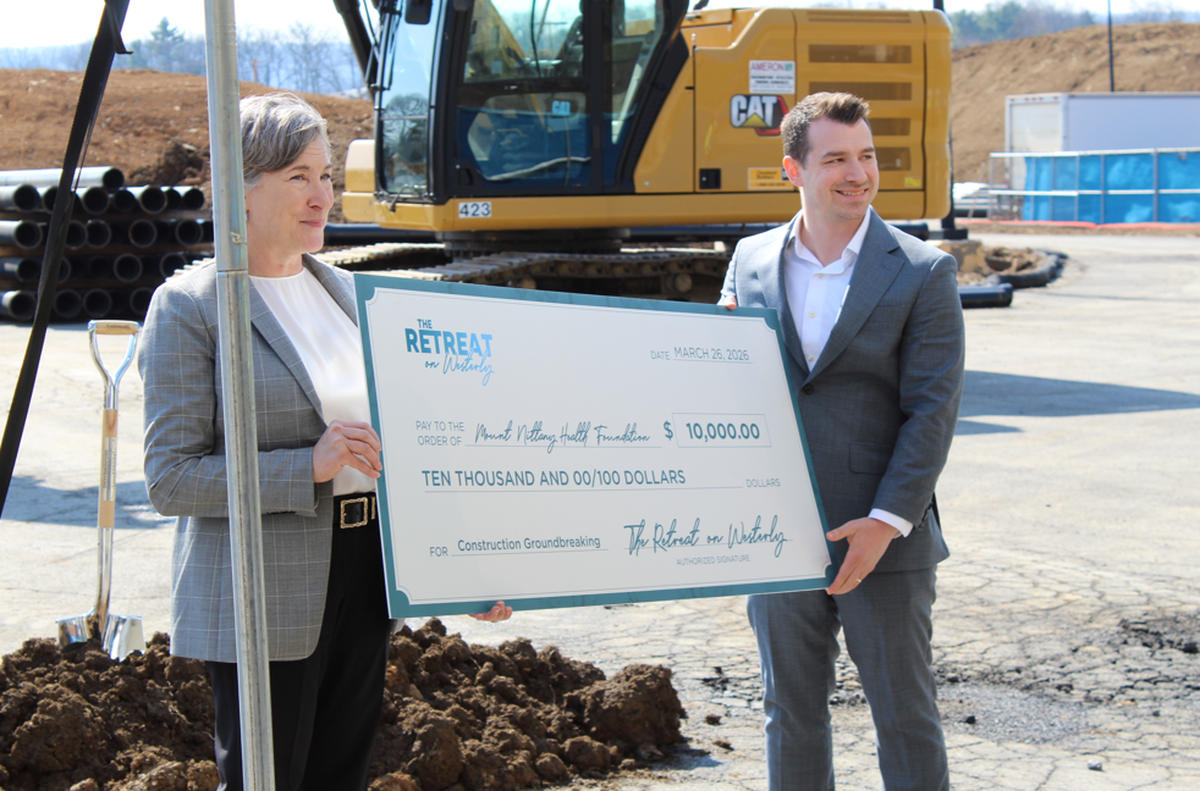 From left, Mount Nittany Health Foundation Executive Director Adrienne Krasowitz and Landmark Properties Development Manager Nick Lev hold up a $10,000 check at The Retreat at Westerly’s groundbreaking.