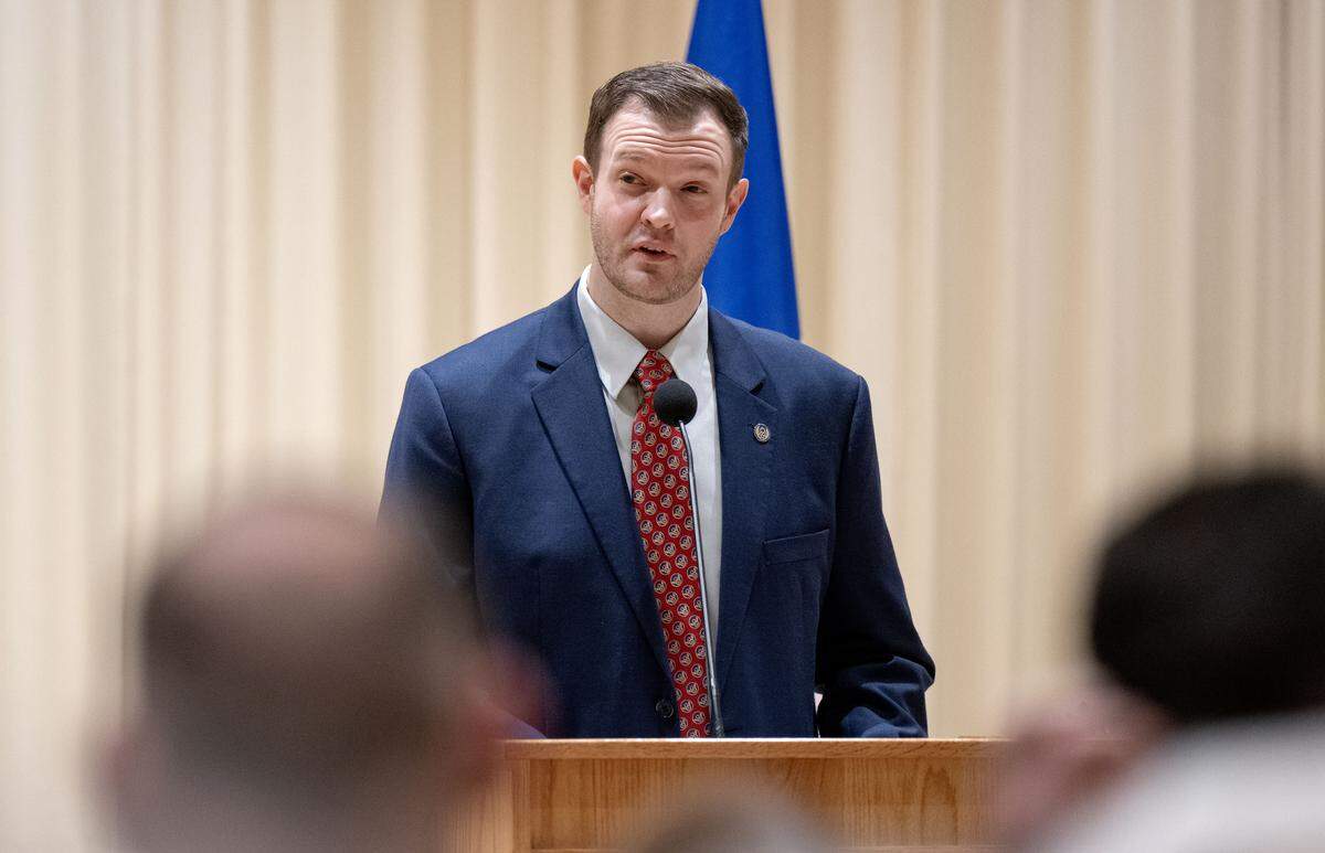Jared Frederick, who helped write John F. Homan’s memoir “Into the Cold Blue,” speaks during a ceremony to honor Homan at Foxdale Village on Wednesday, Dec. 10, 2025.’