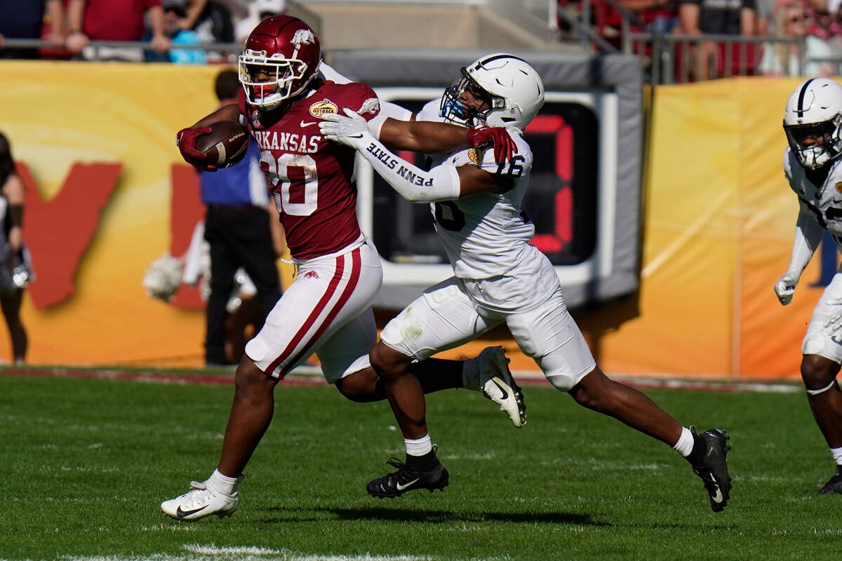 Arkansas running back Dominique Johnson gets stopped by Penn State safety Ji’Ayir Brown during the second half of the Outback Bowl on Saturday.