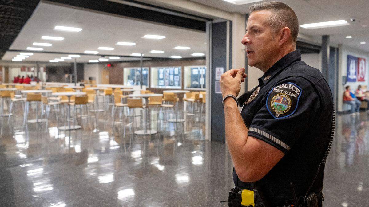 State High school resource officer John Aston looks over the cafeteria Wednesday before the second wave of students arrive for lunch.
