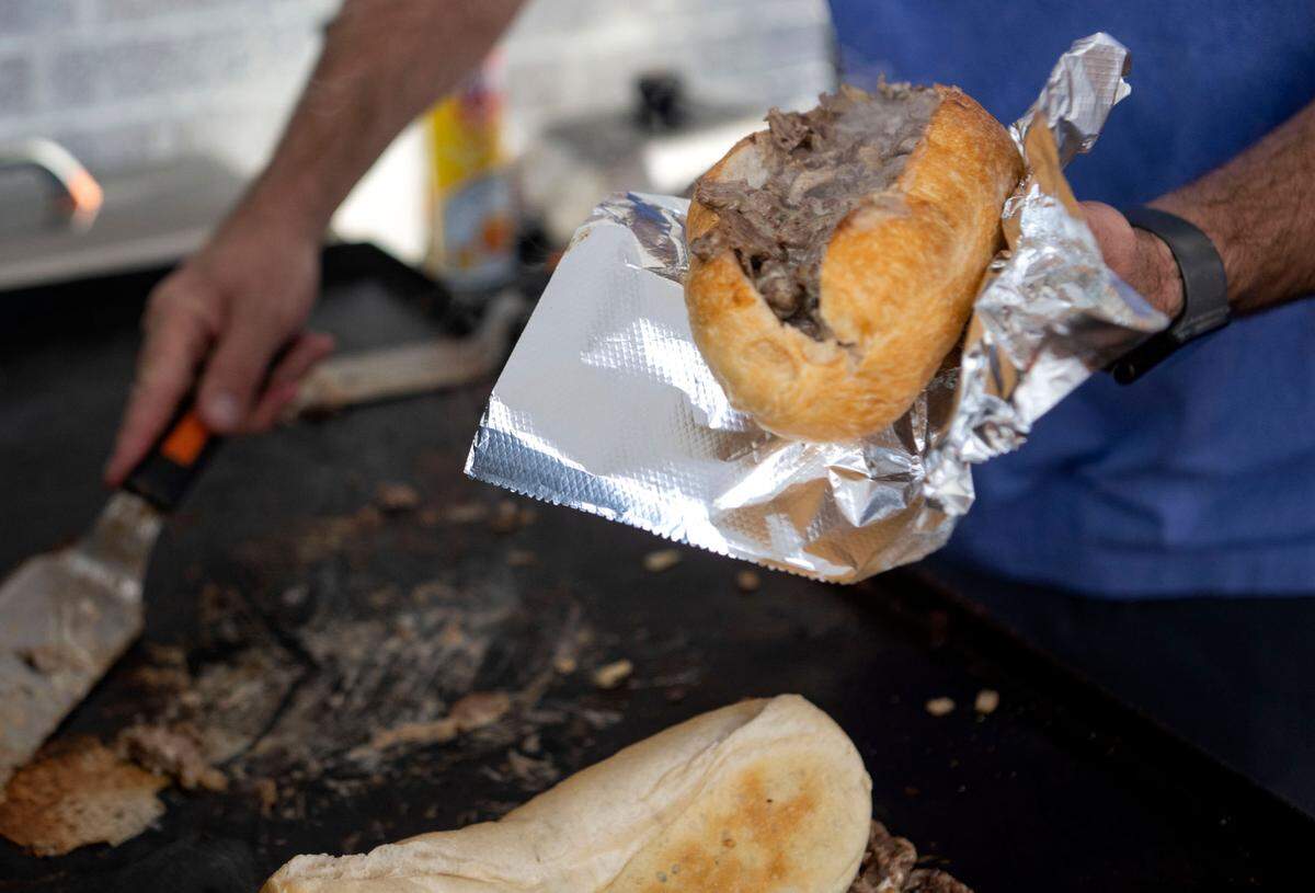 A cheesesteak steams as it comes off the grill for a customer at Uncle John’s Jawns outside of Angtifragile Brewing Co. on Friday, Sept. 22, 2023.