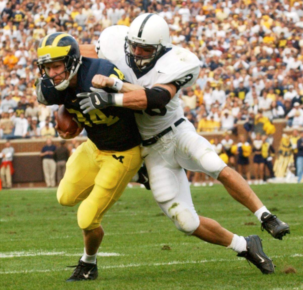 Penn State’s Shawn Mayer stops Michigan place kicker Philips Brabbs on a fake field goal attempt, short of a first down, in Ann Arbor, Mich., Saturday, Oct. 12, 2002.
