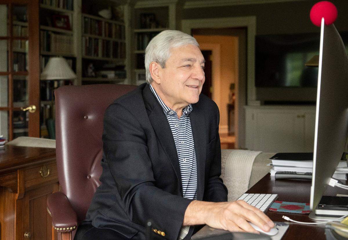 Graham Spanier reads an email from a colleague about his book, “In the Lions Den,” at his home on Thursday, Sept. 8, 2022.