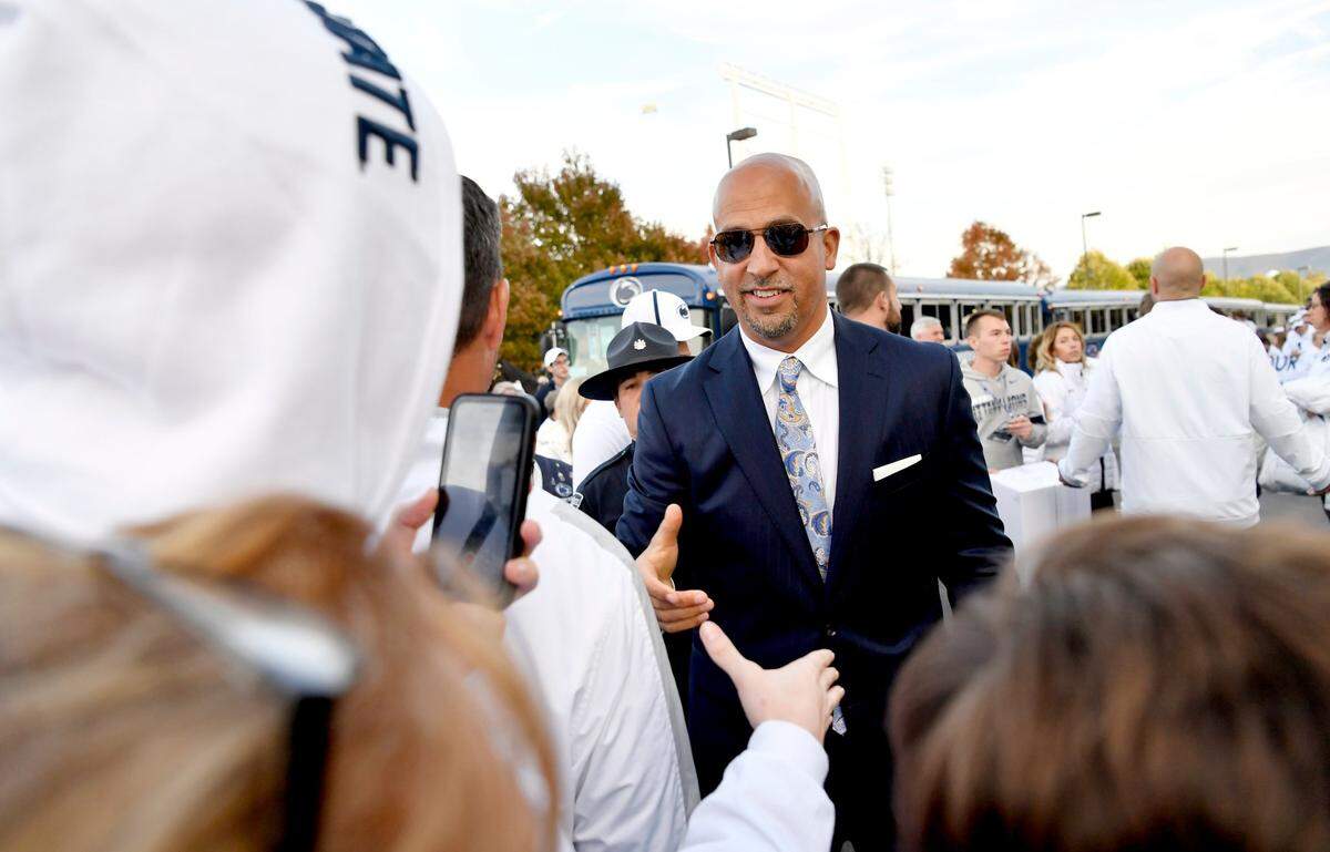 Penn State football coach James Franklin shakes hands with fans as he and the team arrive at Beaver Stadium for the White Out game against Michigan on Saturday, Oct. 19, 2019. Fans can expect the return of team arrival this season, with a “buffer zone.”
