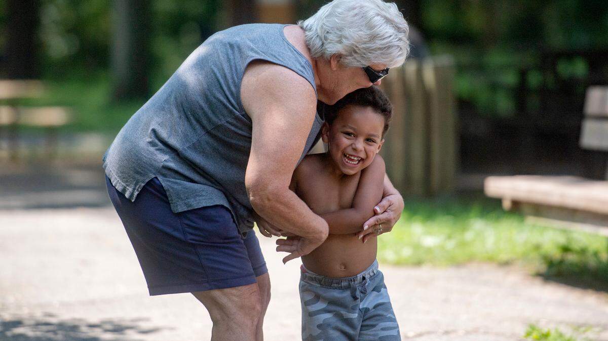 Amy Mitchell hugs her grandson in August 2018 as he giggles after running to her arms. Mitchell recently started a Centre County support group for “grandfamilies.”
