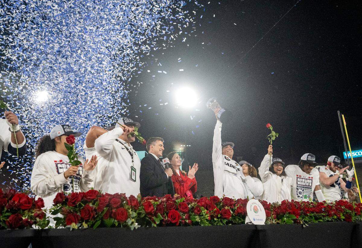 Penn State football coach James Franklin holds up the Leishman Trophy after beating Utah in the Rose Bowl on Monday, Jan. 2, 2023.