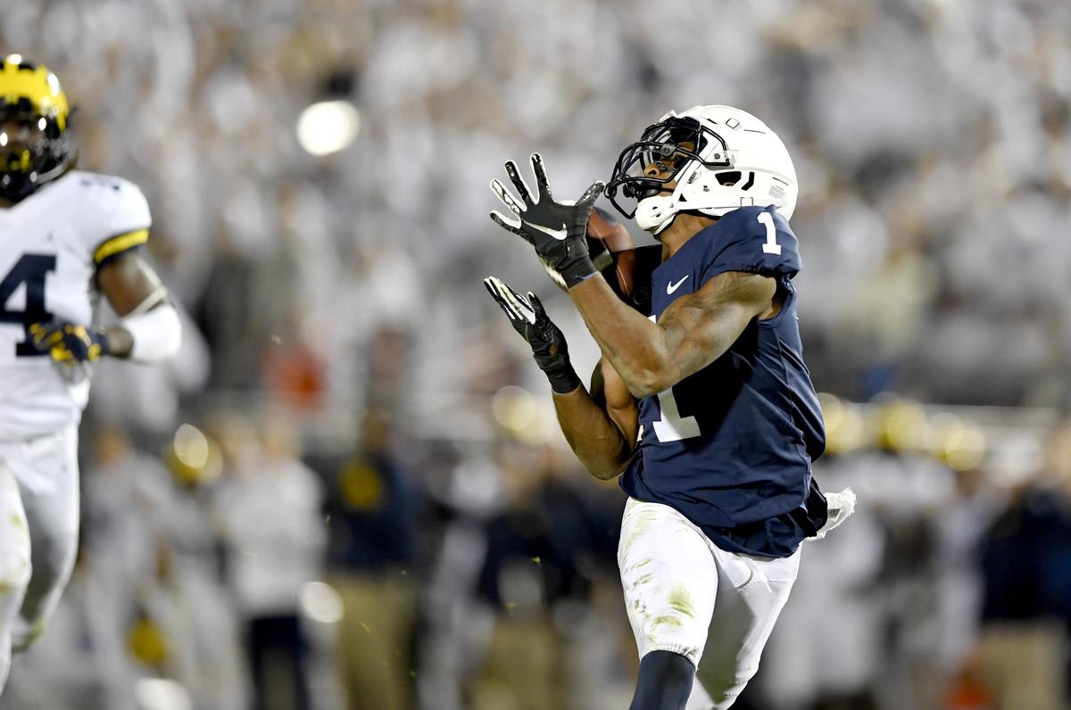 Penn State wide receiver KJ Hamler catches a 53 yard throw from Sean Clifford and runs it in for a touchdown ahead of Michigan defenders during the game on Saturday, Oct. 19, 2019.