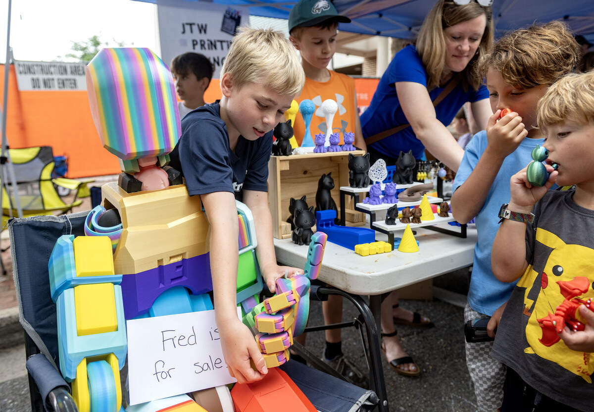 Jake Haas, 11, makes his giant 3D printed figure Fred give a thumbs-up to customers at the Children and Youth Day sidewalk sale at the Central Pennsylvania Festival of the Arts on Wednesday, July 8, 2026.