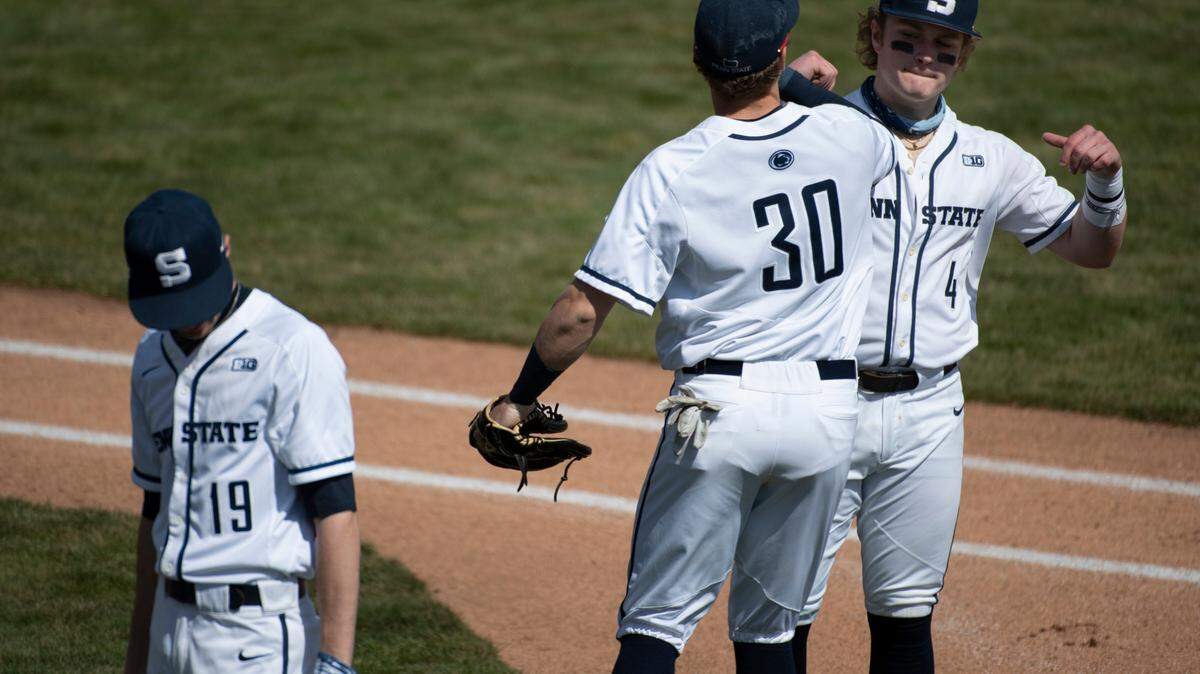 Penn State infielder Kyle Hannon (30) and catcher Tyson Cooper (4) bump fists before a game in 2021.