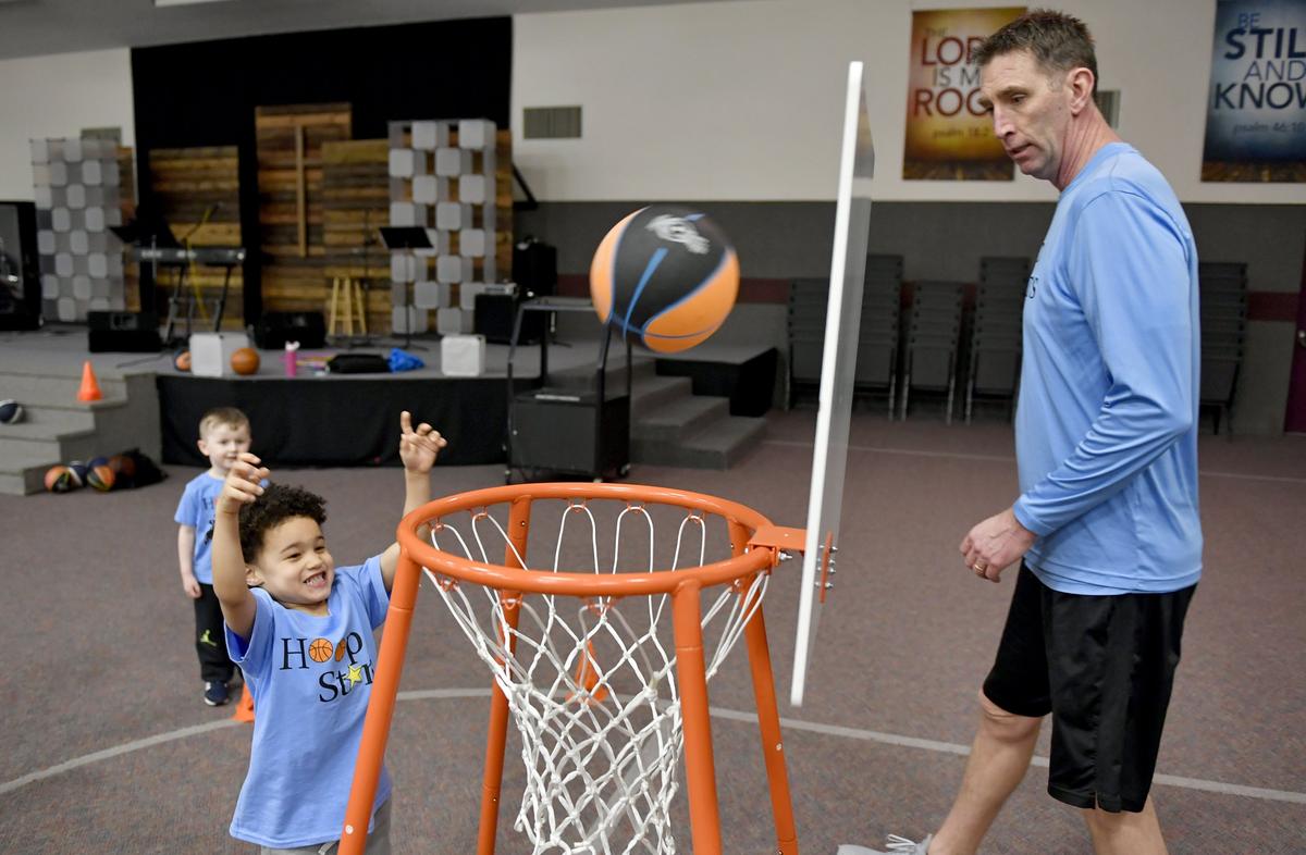 Dan McKenna cheers on Donald Ferrell, 3, as he shoots a basket during a Hoops Stars class at Park Forest Baptist Church on March 4.