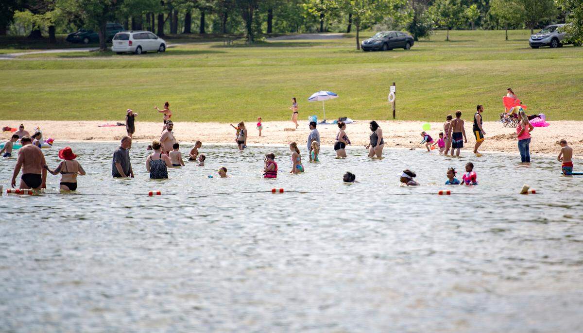 People cool off from the heat at the beach area at Bald Eagle State Park on Monday, June 28, 2021.  