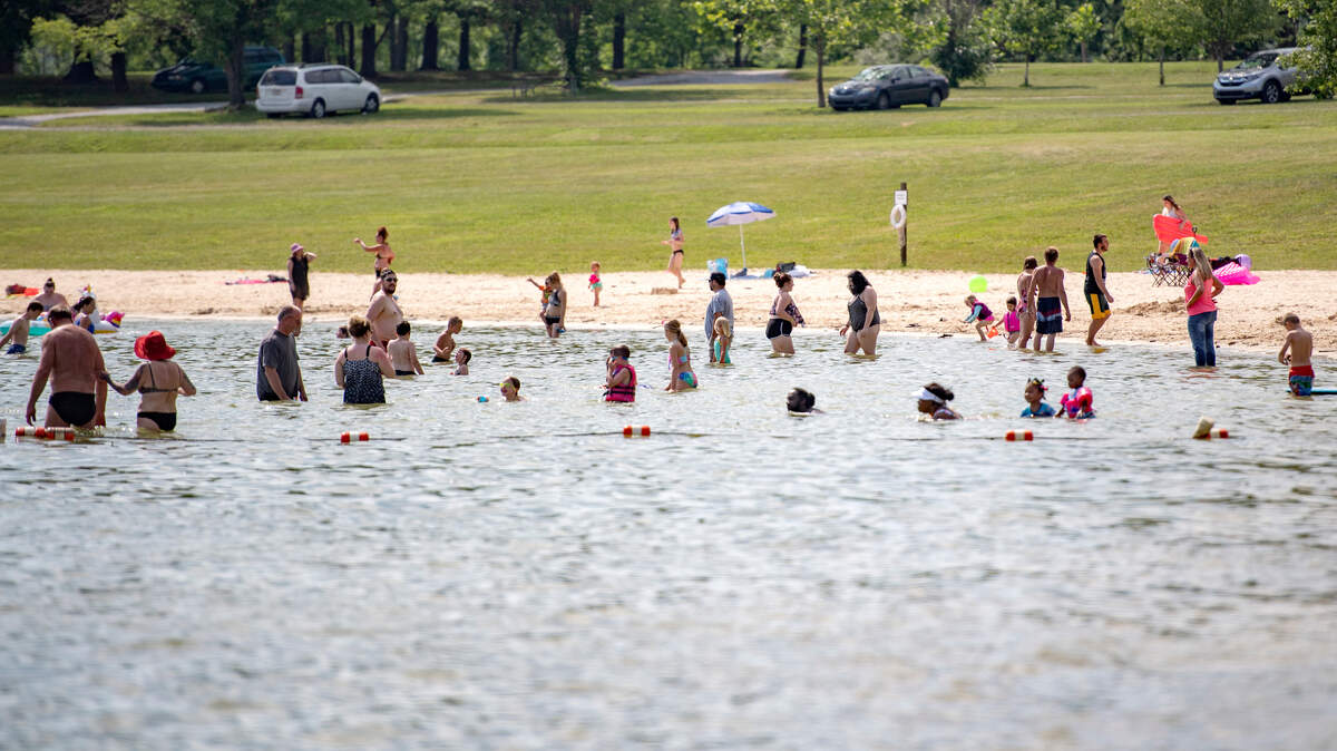 People cool off at Bald Eagle State Park’s beach area in this 2021 file photo.