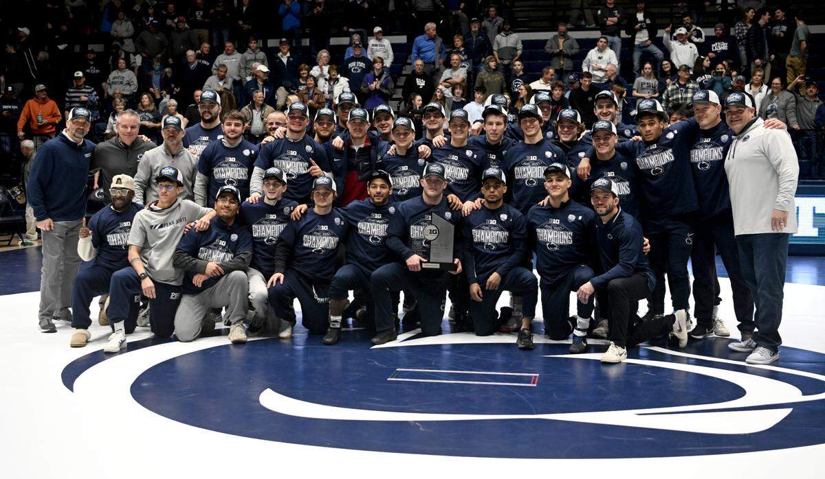 Penn State wrestling celebrates winning the Big Ten dual meet title after the win over Maryland on Sunday, Feb. 12, 2023 at Rec Hall.