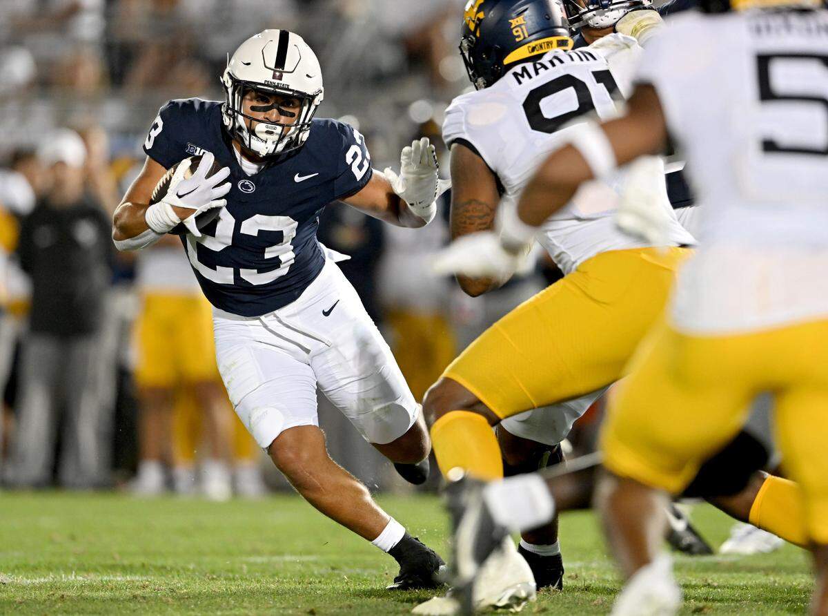 Penn State running back Trey Potts cuts down the field with the ball around West Virginia defenders during the game on Saturday, Sept. 2, 2023.
