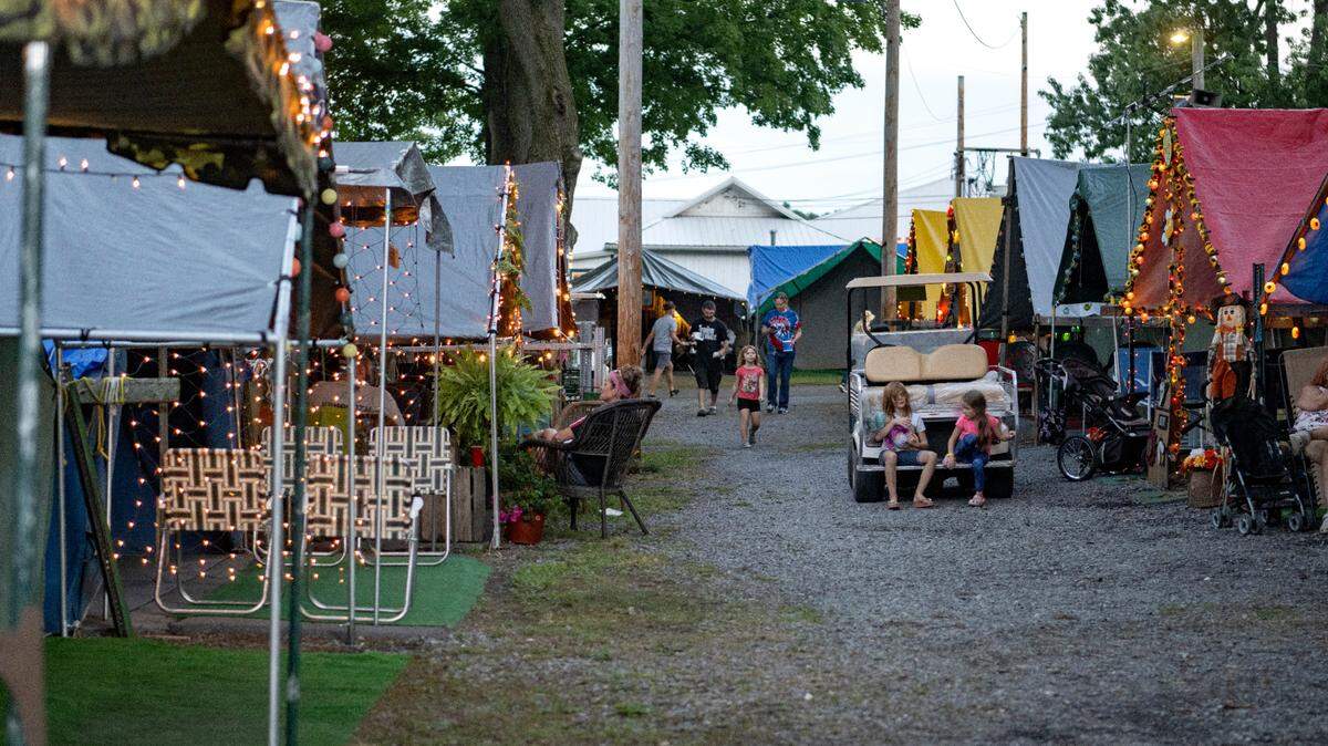 Families hang out at their tents during the Centre County Grange Fair on Monday, Aug. 22, 2022.