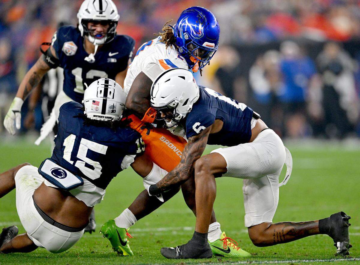 Penn State defensive end Amin Vanover and safety Zakee Wheatley stop Boise State running back Ashton Jeanty during the Fiesta Bowl on Tuesday, Dec. 31, 2024 at State Farm Stadium.