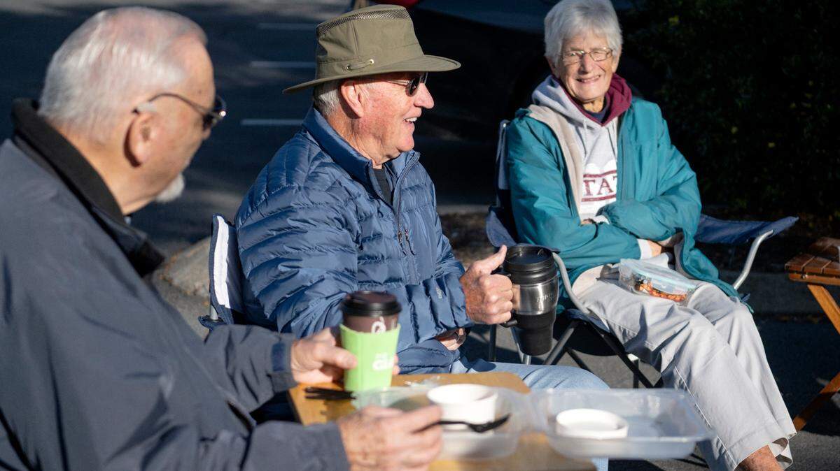 Len Rockey laughs with friends and fellow retired educators during their weekly meetup in the parking lot of the Waffle Shop on Wednesday, Oct. 12, 2022.