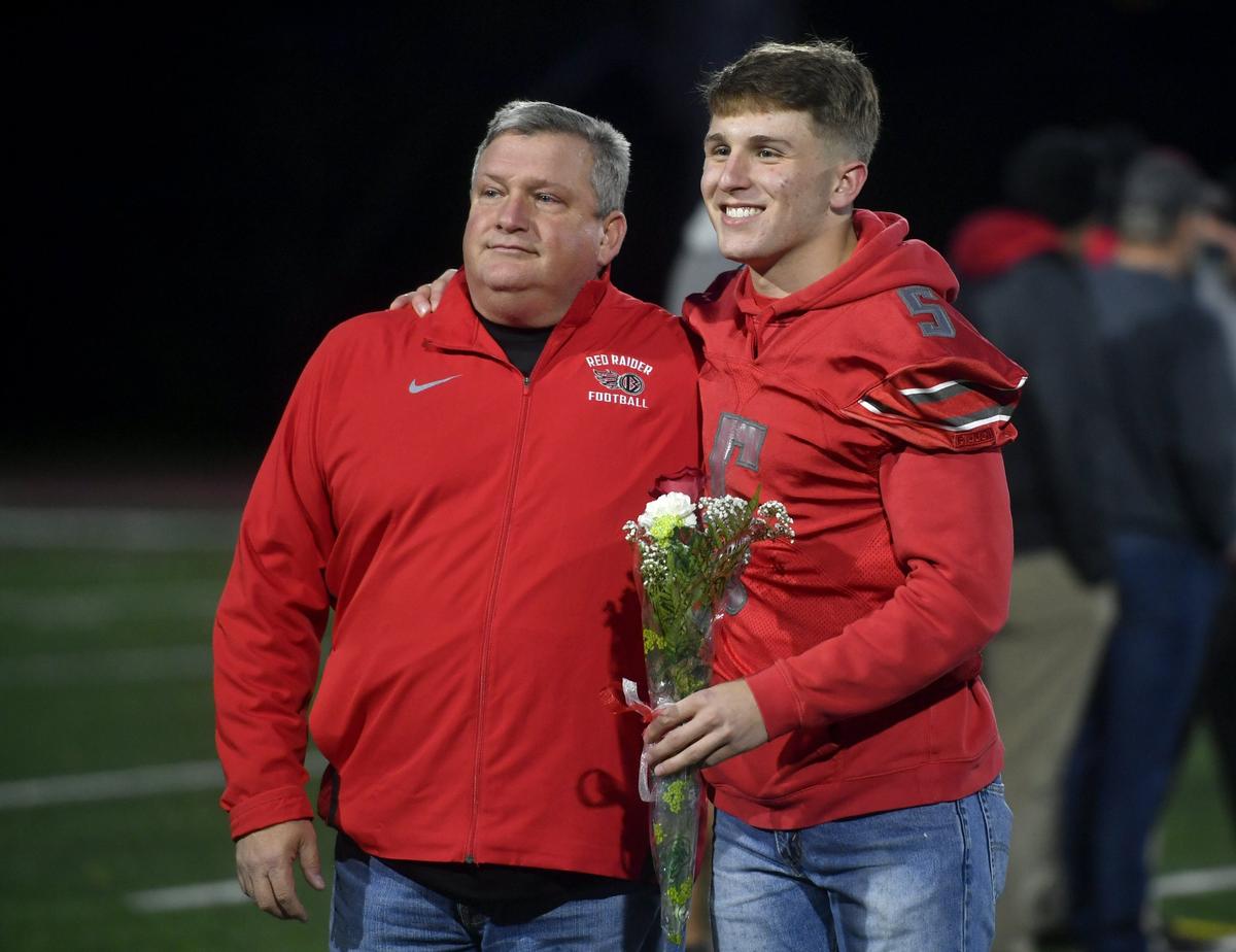 Bellefone’s Trae Bauman smiles for a photo with his dad during the senior night celebration on Friday, Oct. 18, 2019.