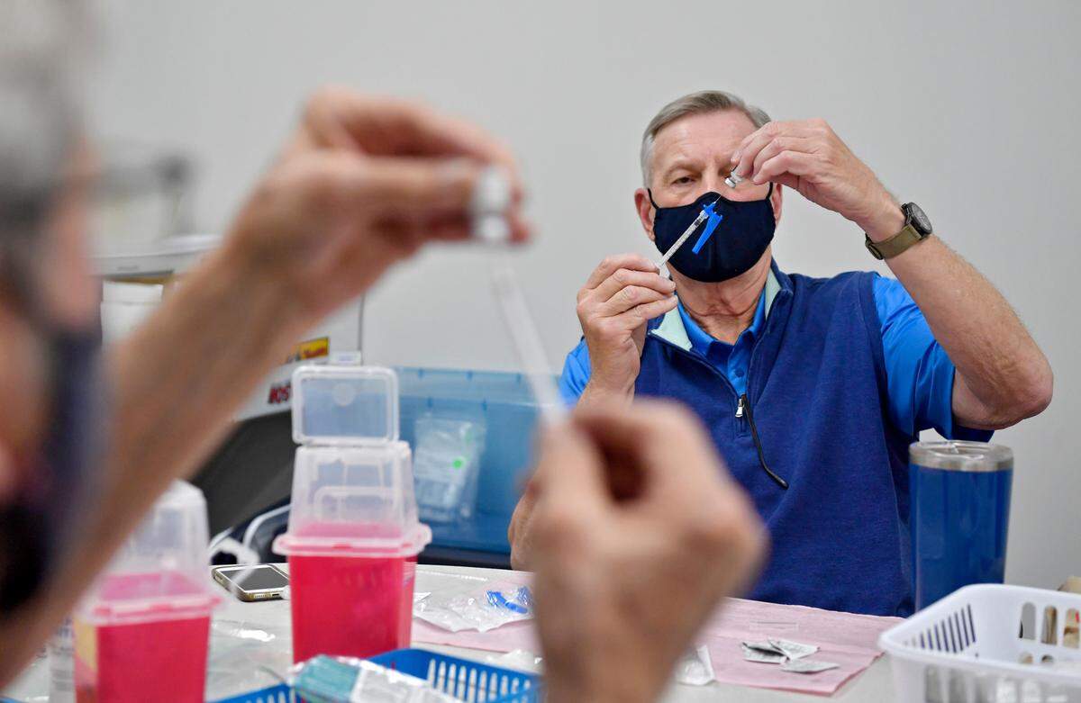 Mark Doyle draws a Pfizer coronavirus vaccine for patients at the CVIM vaccine clinic on May 13 at Panorama Village. CVIM has given more than 35,000 doses of the COVID-19 vaccine.