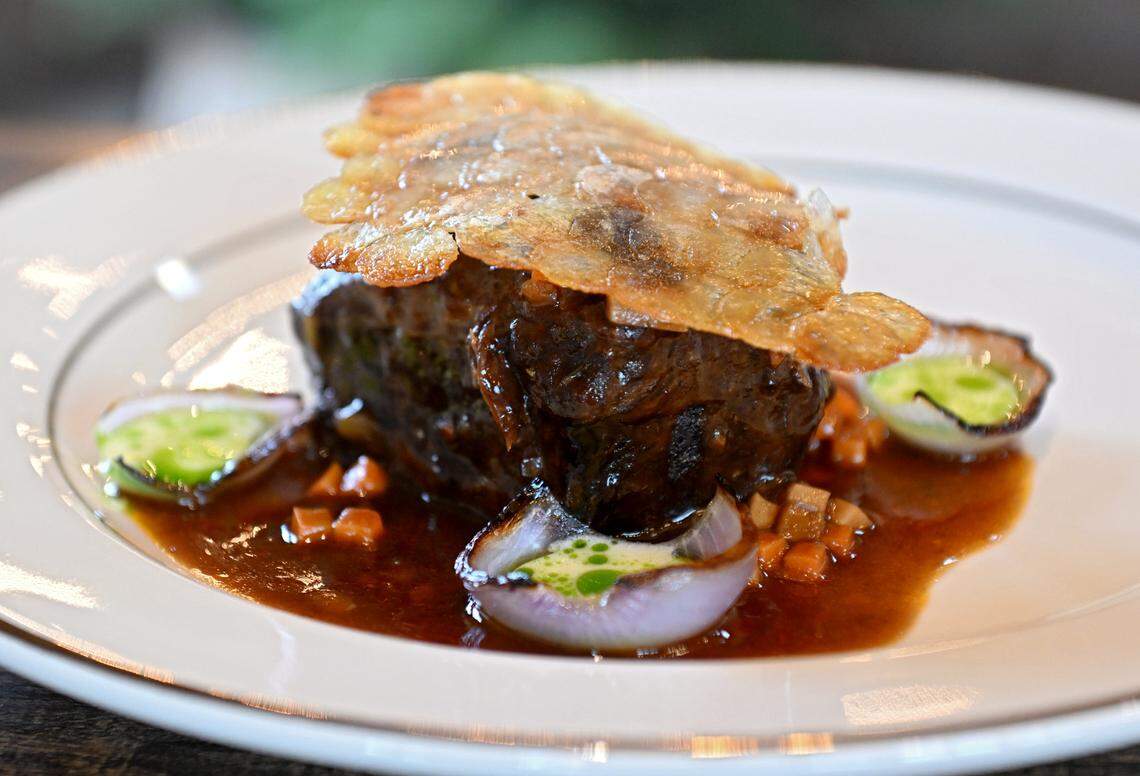 Braised Grove Valley Farm short rib, scallop potatoes, yuzu ponzu shiitake mushrooms, charred onion with a horseradish buttermilk and dill oil at the Studebaker House.  