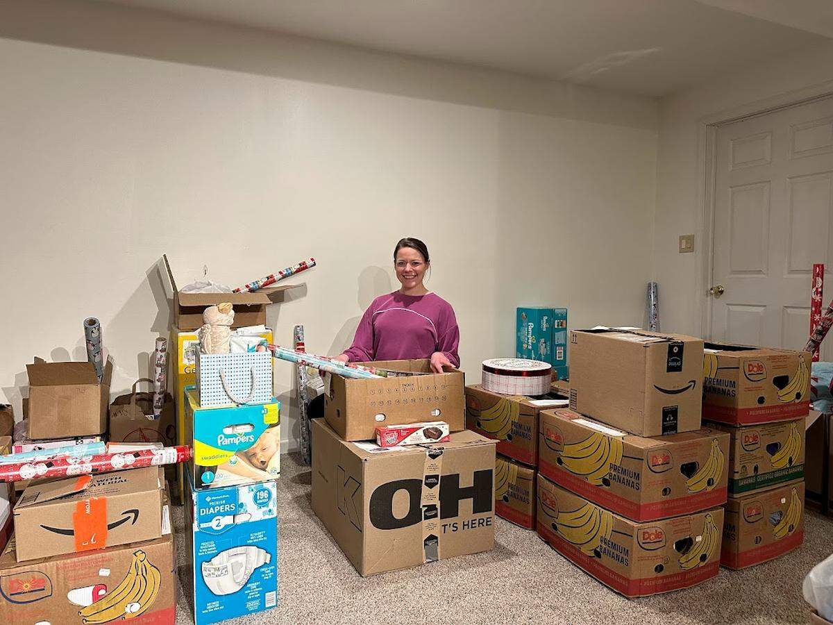 Ashley Molek, the founder and executive director of the nonprofit A Christmas Wish, organizes some of the gifts that are destined for more than 220 Centre County children.