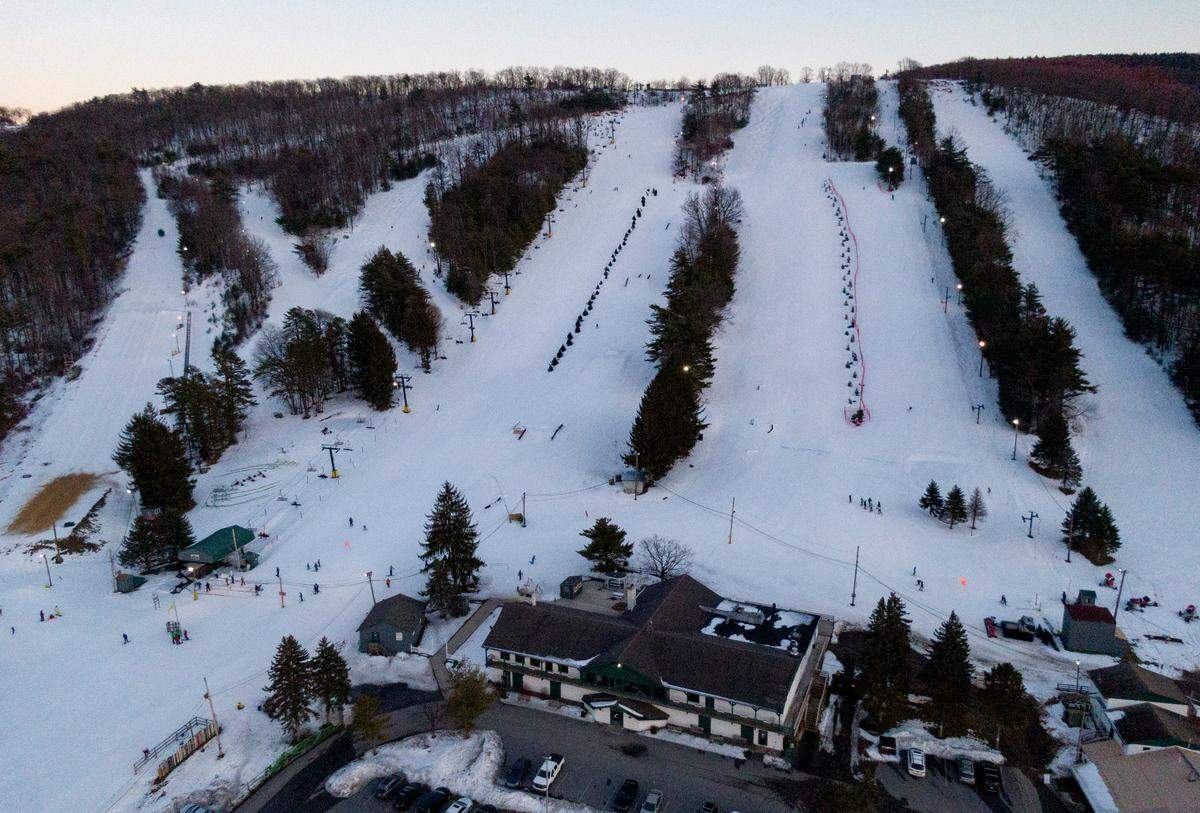 The sun sets as skiers and snowboarders enjoy Tussey Mountain on Thursday, Feb. 25, 2021.