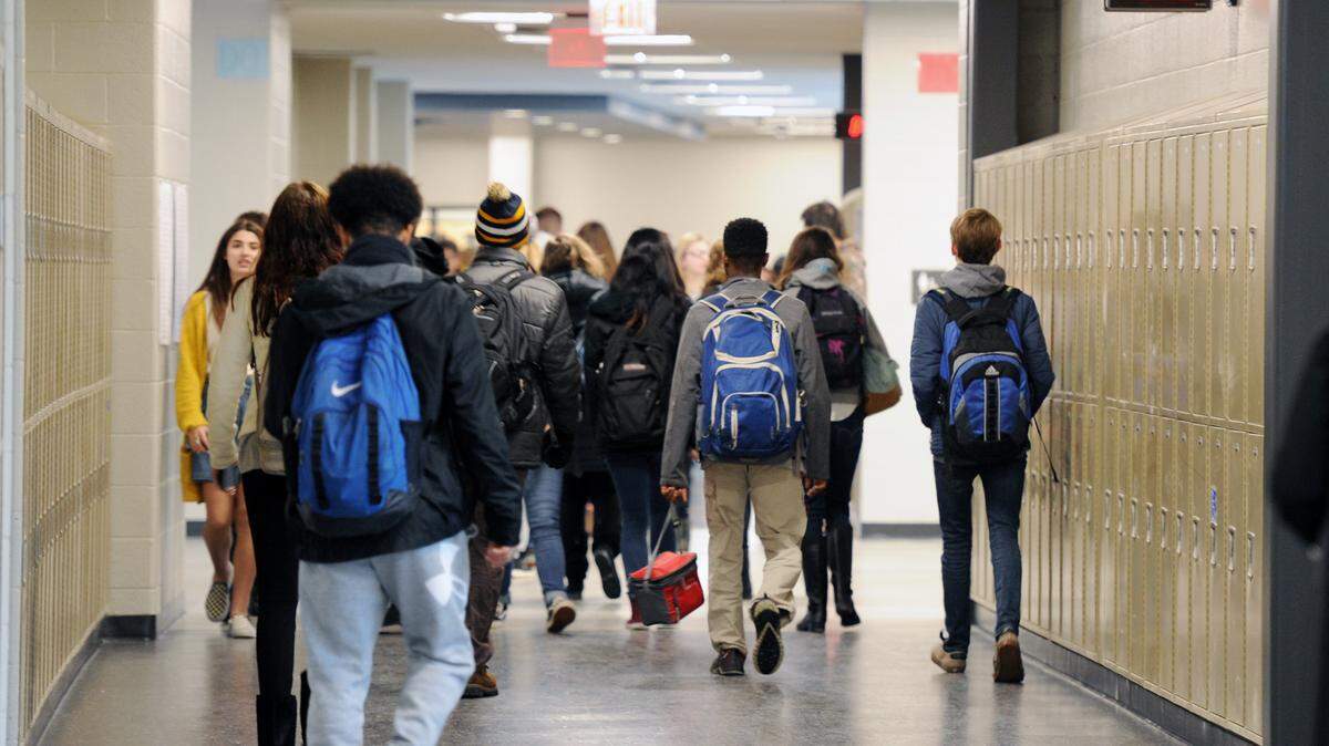 Students walk the halls of the State College High School building Monday, Jan. 8, 2018.