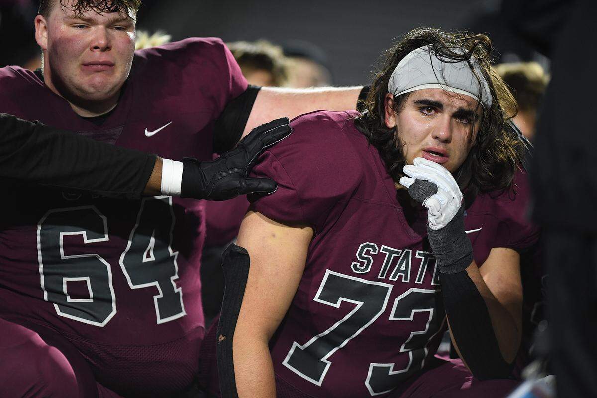 State College’s TJ Bowser, left, and Luke Milito huddle with their teammates follow their 42-21 loss to Central Catholic’s  in PIAA Class 6A quarterfinal game Friday, Nov. 21, 2025, at Altoona’s Mansion Park.