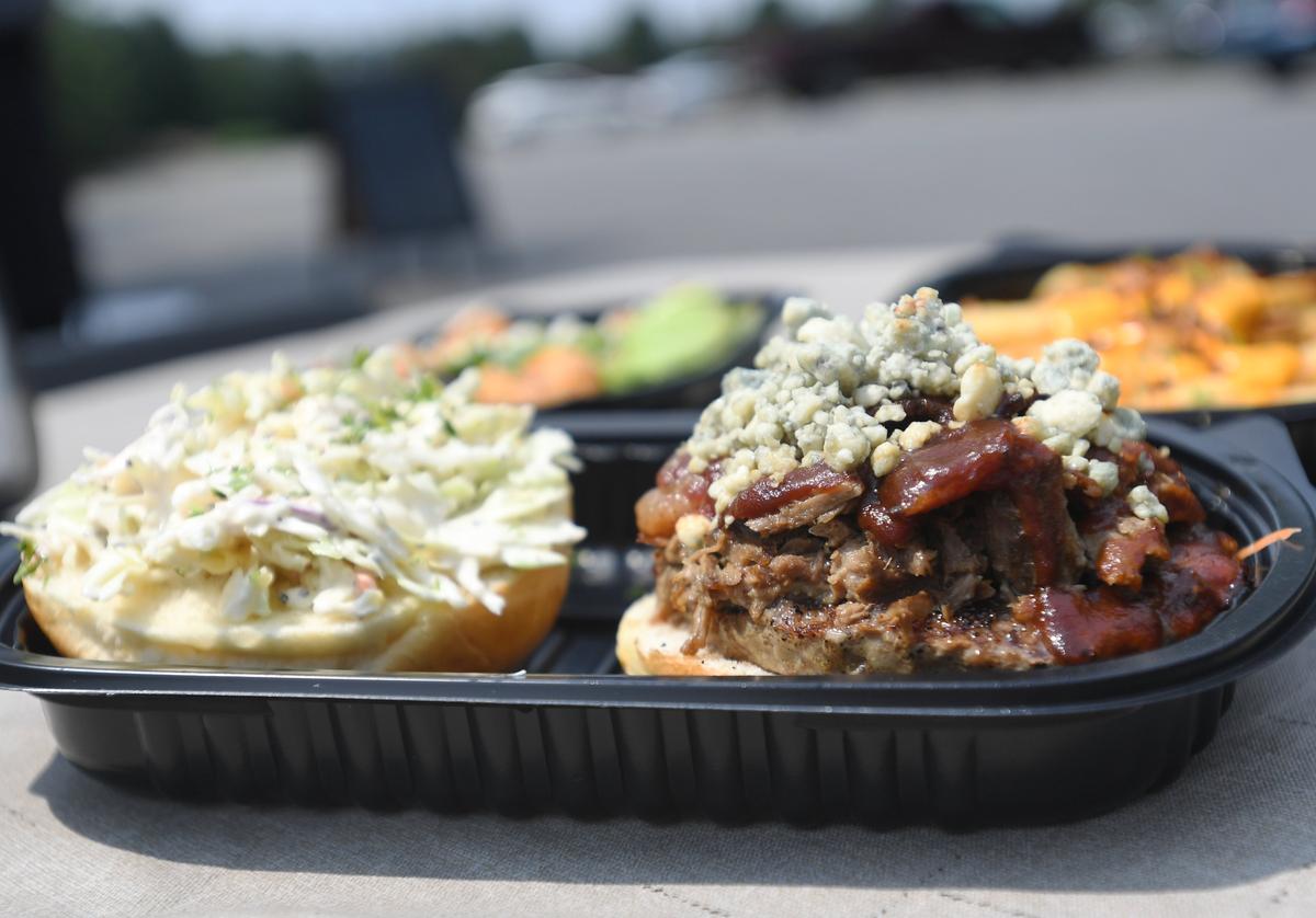 “The Happy Burger” at the Happy Dishes food trailer is a 10 oz. Angus burger topped with beef brisket, applewood bacon, blue cheese, coleslaw and barbecue sauce.