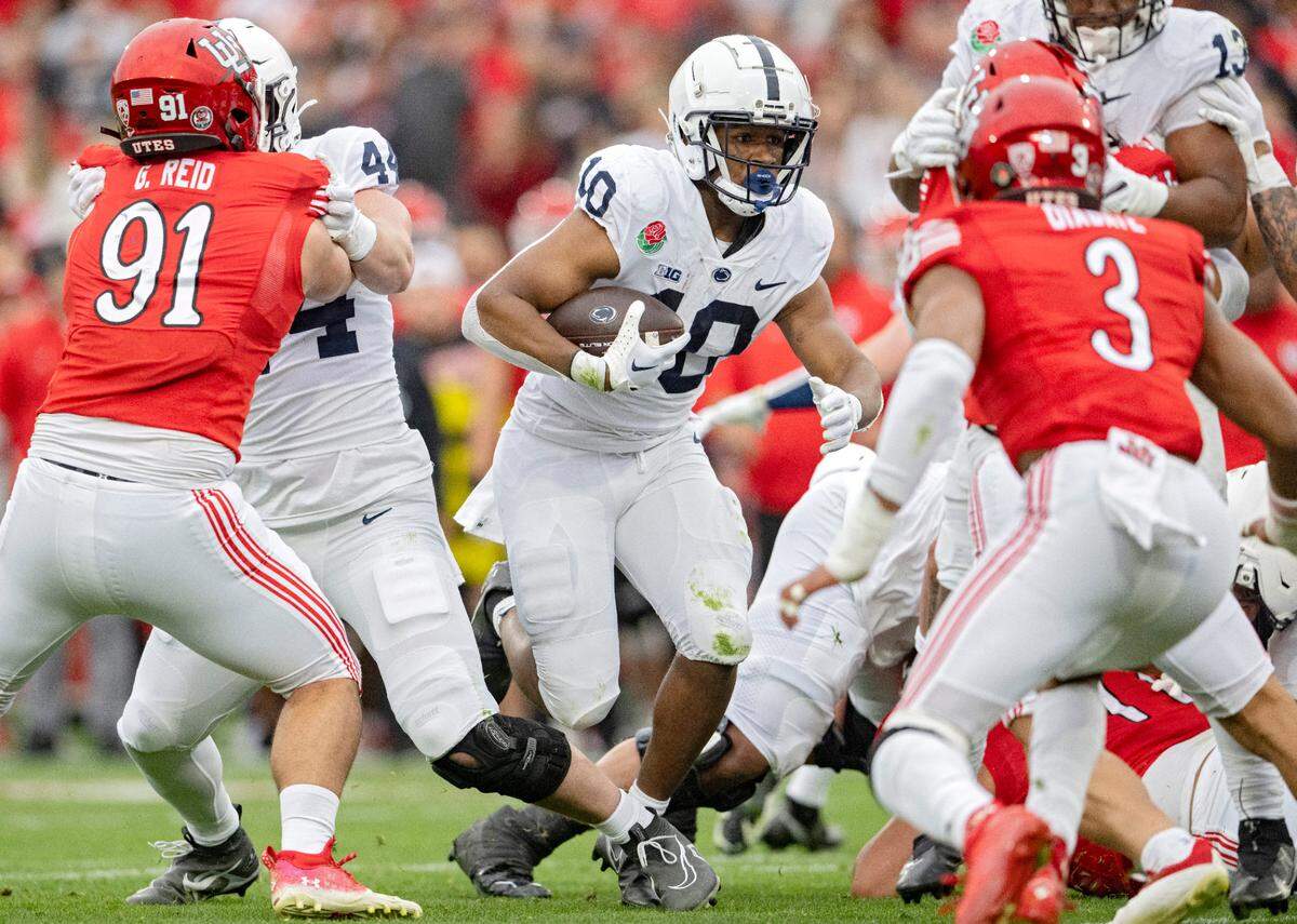 Penn State running back Nick Singleton cuts through Utah defenders for the first touchdown of the Rose Bowl game on Monday, Jan. 2, 2023.